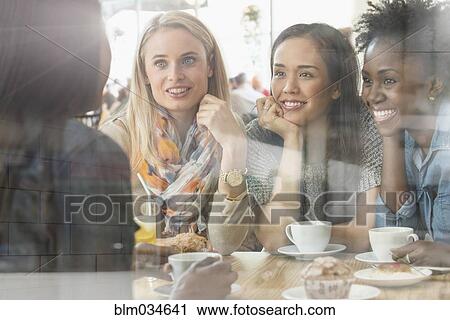 Stock Image - Women eating breakfast in cafe. Fotosearch
