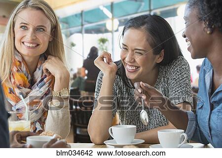 Stock Image - Women eating breakfast in cafe. Fotosearch