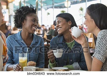 Stock Image - Women eating breakfast in cafe. Fotosearch