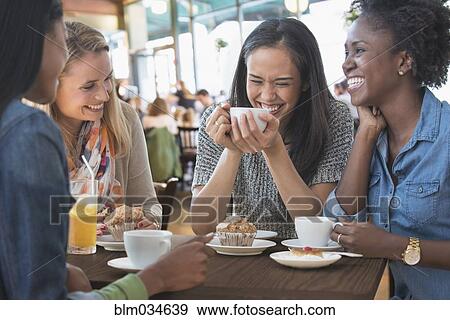 Stock Photo - Women eating breakfast in cafe. Fotosearch