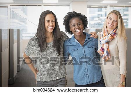 Picture - Women smiling in office. Fotosearch