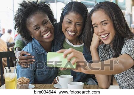 Women taking selfie in cafe View Large Photo Image Picture - Women taking selfie in cafe. Fotosearch