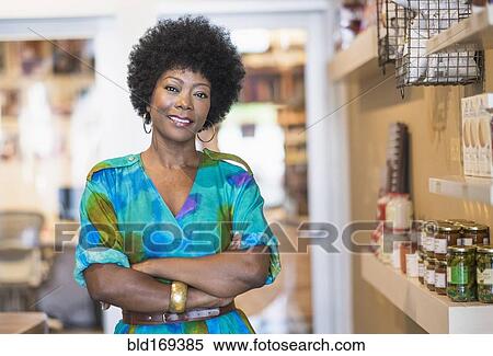 Stock Photography - African American business owner smiling in store. Fotosearch