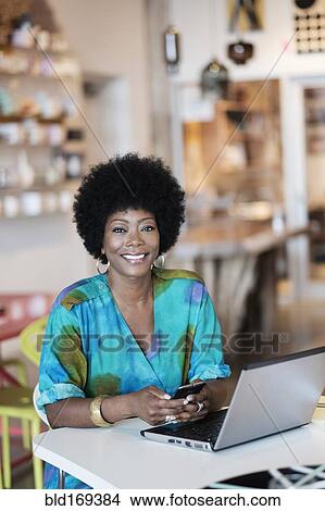African American business owner using laptop in store View Large Photo Image Picture - African American business owner using laptop in store. Fotosearch