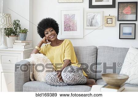 African American woman relaxing on sofa View Large Photo Image Stock Photo - African American woman relaxing on sofa. Fotosearch
