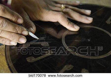 Stock Photo - Asian artisan carving traditional design. Fotosearch
