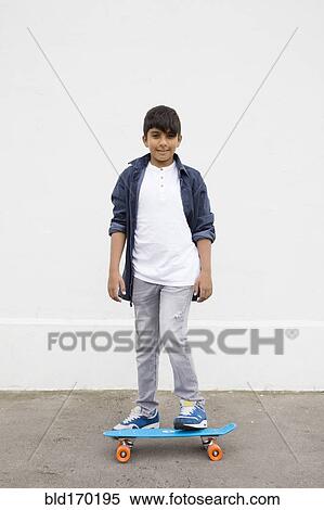 Asian boy standing on skateboard View Large Photo Image Stock Photography - Asian boy standing on skateboard. Fotosearch
