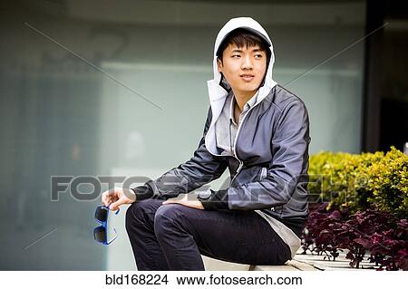 Asian man waiting in city View Large Photo Image Picture - Asian man waiting in city. Fotosearch