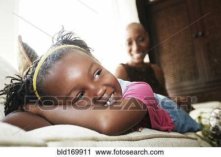 Black girl laying on sofa View Large Photo Image Stock Image - Black girl laying on sofa. Fotosearch