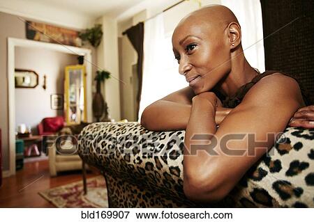 Stock Photo - Black woman relaxing on sofa. Fotosearch