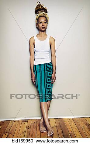 Black woman standing barefoot at wall View Large Photo Image Stock Image - Black woman standing barefoot at wall. Fotosearch