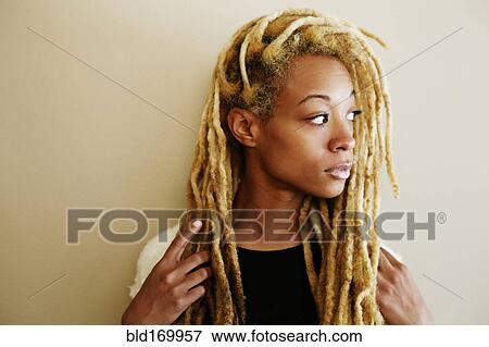 Black woman with dreadlocks looking away View Large Photo Image Stock Photo - Black woman with dreadlocks looking away. Fotosearch
