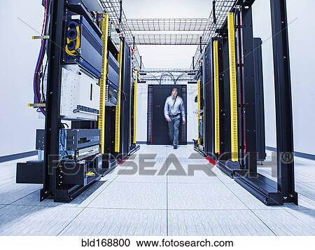 Blurred view of Hispanic technician walking in server room View Large Photo Image Stock Image - Blurred view of Hispanic technician walking in server room. Fotosearch