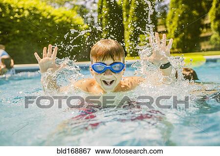 Stock Photo - Boy splashing in swimming pool. Fotosearch