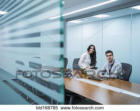 Stock Photography - Business people smiling in conference room. Fotosearch