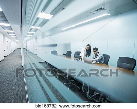 Business people using laptop in conference room View Large Photo Image Stock Image - Business people using laptop in conference room. Fotosearch