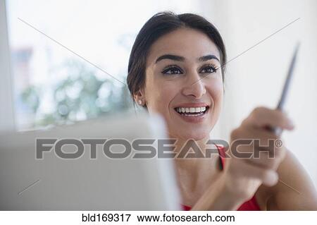 Stock Photo - Businesswoman gesturing with pen. Fotosearch