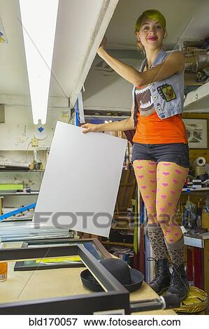Stock Photo - Caucasian artist working in screen print workshop. Fotosearch