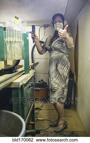 Stock Image - Caucasian artist working in workshop. Fotosearch