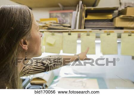Stock Photograph - Caucasian artist working in workshop. Fotosearch