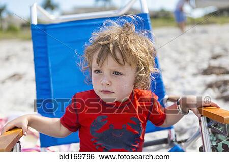 Caucasian baby boy sitting in lawn chair on beach View Large Photo Image Stock Photograph - Caucasian baby boy sitting in lawn chair on beach. Fotosearch