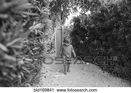 Stock Image - Caucasian baby boy walking in backyard. Fotosearch