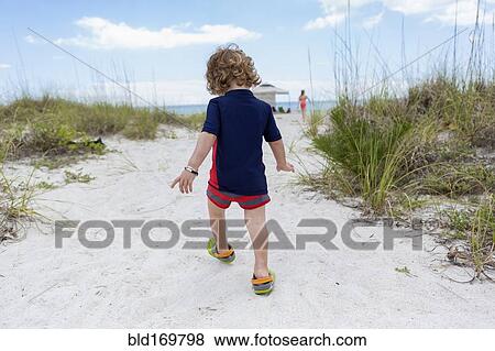 Caucasian baby boy walking on beach View Large Photo Image Stock Photo - Caucasian baby boy walking on beach. Fotosearch