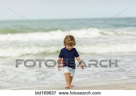 Caucasian baby boy walking on beach View Large Photo Image Stock Photo - Caucasian baby boy walking on beach. Fotosearch