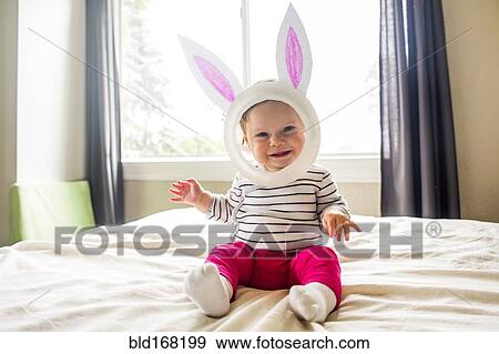 Stock Photo - Caucasian baby girl wearing Easter Bunny costume. Fotosearch