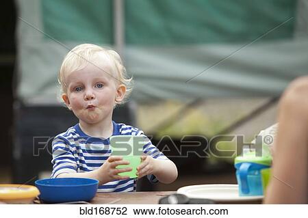 Caucasian boy eating at campsite View Large Photo Image Stock Image - Caucasian boy eating at campsite. Fotosearch