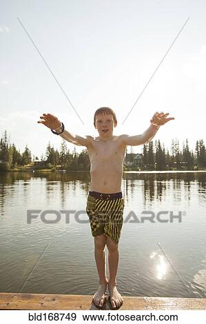 Stock Photo - Caucasian boy falling backwards into lake. Fotosearch