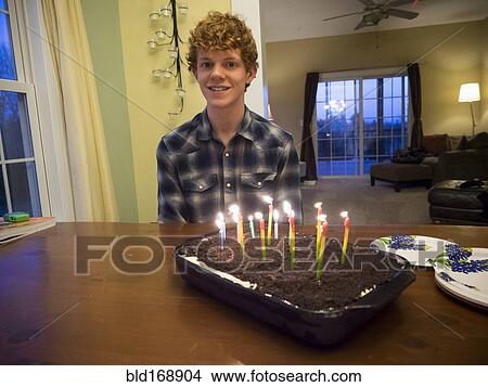 Picture - Caucasian boy smiling with birthday cake. Fotosearch