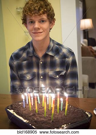 Stock Photography - Caucasian boy smiling with birthday cake. Fotosearch