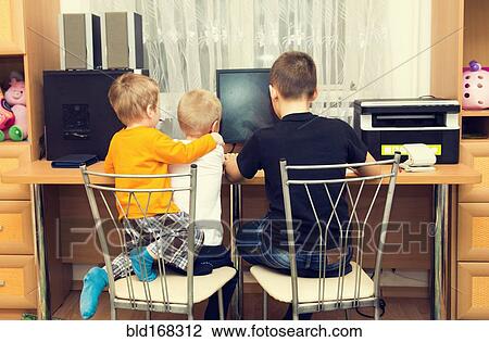 Caucasian brothers using computer in bedroom View Large Photo Image Stock Image - Caucasian brothers using computer in bedroom. Fotosearch