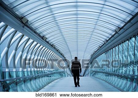 Caucasian businessman walking in tunnel View Large Photo Image Stock Image - Caucasian businessman walking in tunnel. Fotosearch