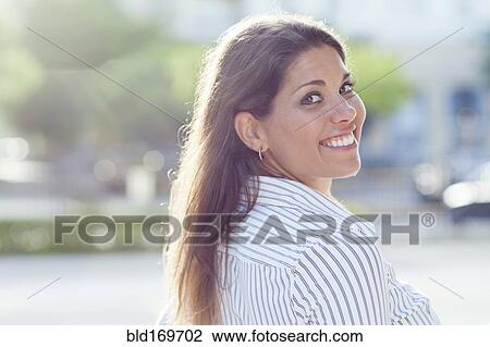 Stock Image - Caucasian businesswoman smiling outdoors. Fotosearch