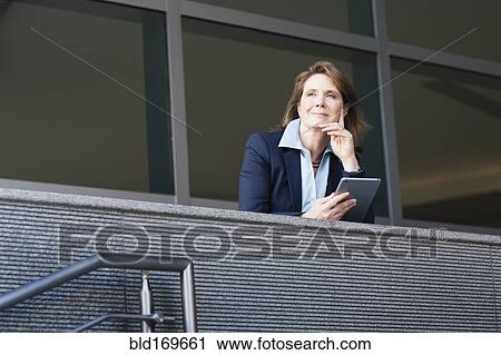 Caucasian businesswoman using digital tablet on balcony View Large Photo Image Stock Image - Caucasian businesswoman using digital tablet on balcony. Fotosearch