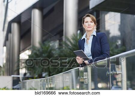 Caucasian businesswoman using digital tablet outdoors View Large Photo Image Stock Photograph - Caucasian businesswoman using digital tablet outdoors. Fotosearch