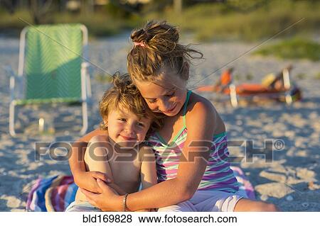 Caucasian children hugging on beach View Large Photo Image Stock Photo - Caucasian children hugging on beach. Fotosearch