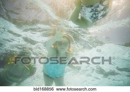 Caucasian children swimming underwater in swimming pool View Large Photo Image Stock Photograph - Caucasian children swimming underwater in swimming pool. Fotosearch