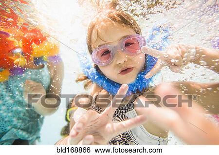 Caucasian children swimming underwater in swimming pool View Large Photo Image Stock Photograph - Caucasian children swimming underwater in swimming pool. Fotosearch