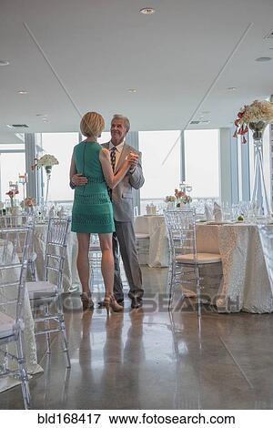 Stock Photo - Caucasian couple dancing in empty restaurant. Fotosearch