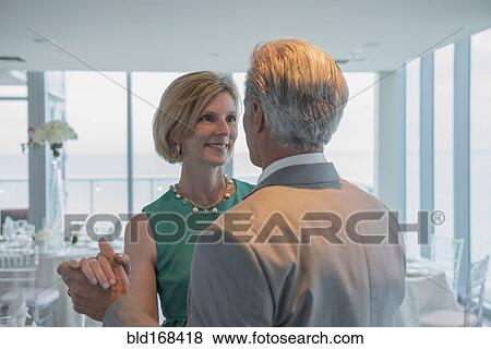Stock Photo - Caucasian couple dancing in empty restaurant. Fotosearch
