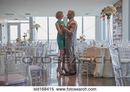 Stock Photography - Caucasian couple dancing in empty restaurant. Fotosearch