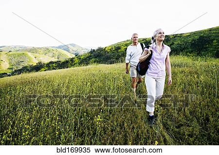 Caucasian couple hiking on hillside View Large Photo Image Stock Photography - Caucasian couple hiking on hillside. Fotosearch