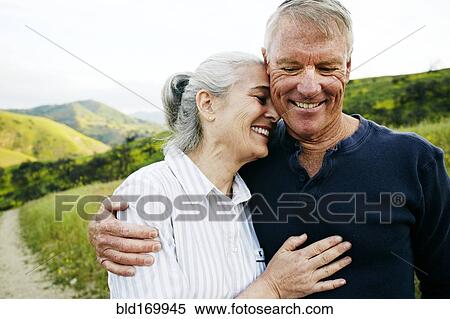 Caucasian couple hugging on hiking trail View Large Photo Image Stock Photography - Caucasian couple hugging on hiking trail. Fotosearch