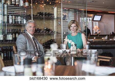 Caucasian couple sitting in restaurant View Large Photo Image Stock Image - Caucasian couple sitting in restaurant. Fotosearch