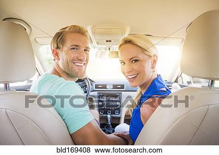 Stock Photo - Caucasian couple smiling in car. Fotosearch