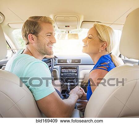 Caucasian couple smiling in car View Large Photo Image Stock Photo - Caucasian couple smiling in car. Fotosearch