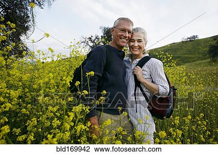 Caucasian couple standing in tall grass View Large Photo Image Stock Image - Caucasian couple standing in tall grass. Fotosearch